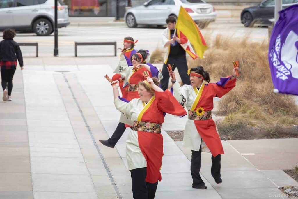 Tatsumaki Yosakoi dancers freestyle dance in front of Lenexa Public Market. Photo by Shadow James.