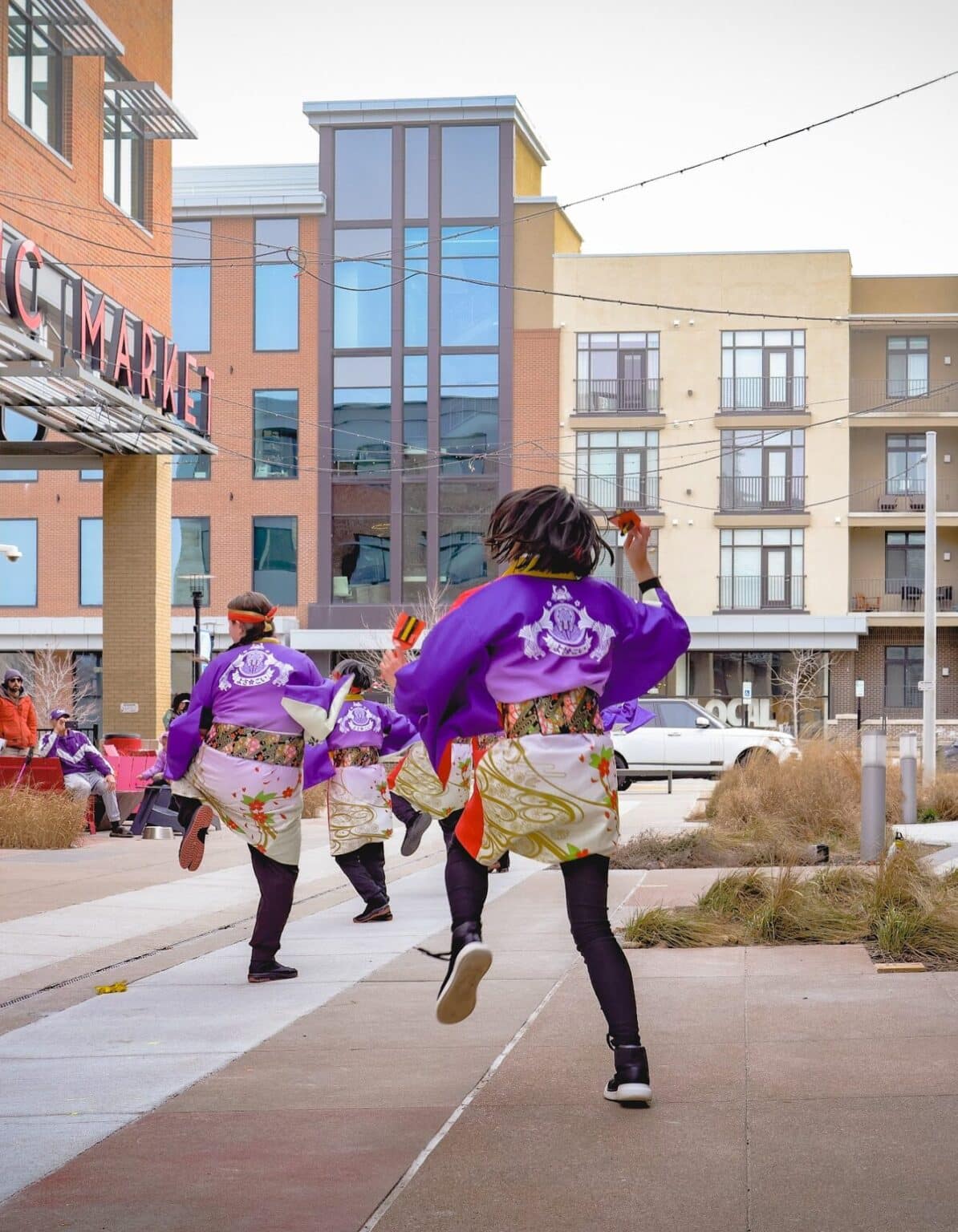 Image of energetic yosakoi dancers at Lenexa Public Market's 2024 Lunar New Year event. Photo by Shadow James.